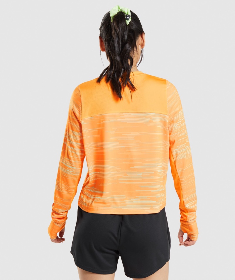 Gymshark športové Voľné Tričko S Dlhým Rukávom S Oranžovou Potlačou